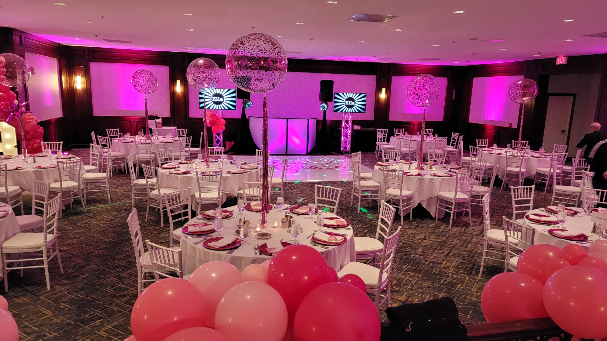 Event room with tables, chairs, and balloons